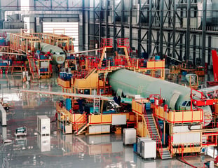 Commercial aircraft receiving maintenance in an MRO warehouse facility
