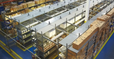High-angle view of organized industrial warehouse shelving stacked with boxed inventory and supplies